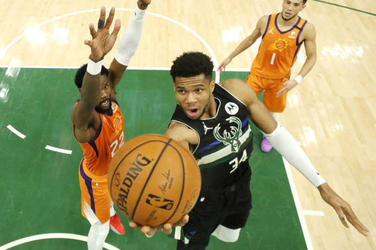 Milwaukee Bucks star forward Giannis Antetokounmpo goes up for a shot past Phoenix's Deandre Ayton in Tuesday's sixth game of the NBA Finals, in which the Greek star scored 50 points to power the Bucks over the Suns to win their first title since 1971