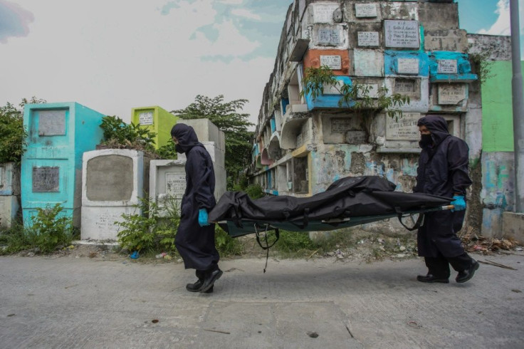 Workers in Manila carry the remains of a man killed in the Philippines' drugs war, which activists estimate has killed tens of thousands of people