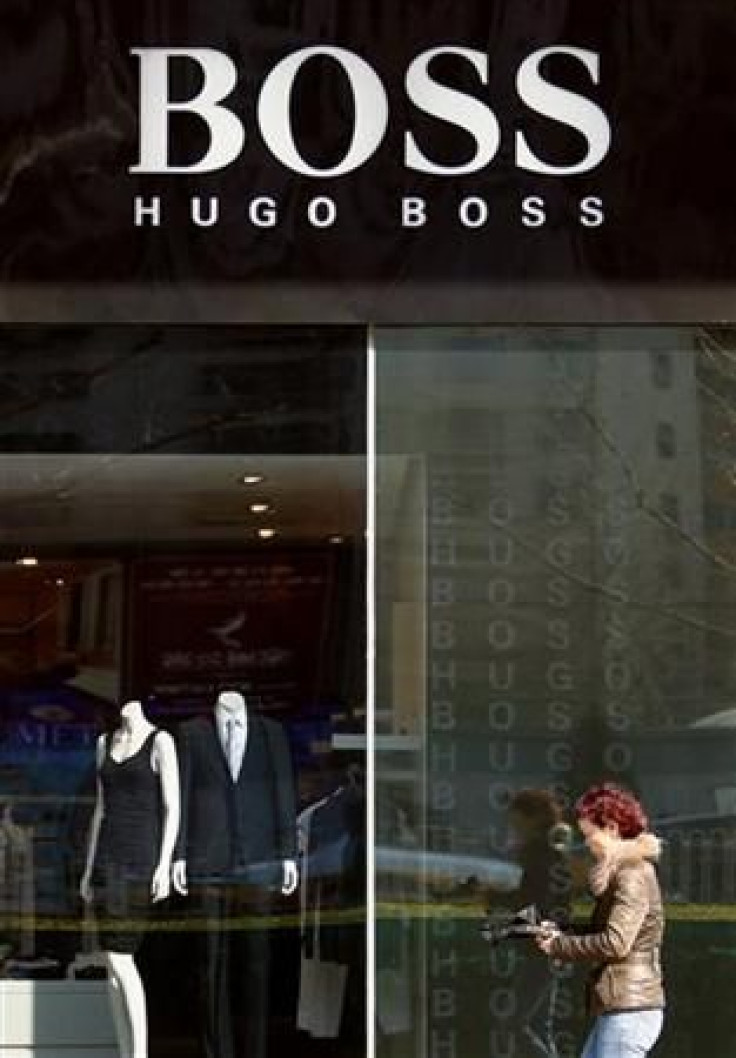 A shopper walks past a Hugo Boss store in central Beijing