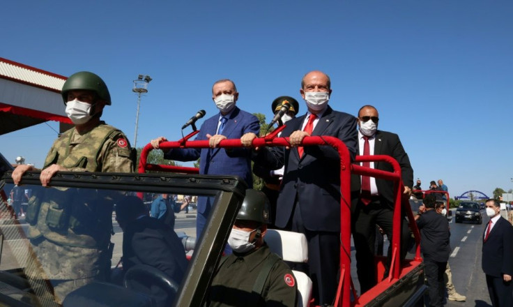 Turkish Cypriot leader Ersin Tatar (right) and Turkish President Recep Tayyip Erdogan (left) take part in a parade in the northern part of Cyprus' divided capital Nicosia