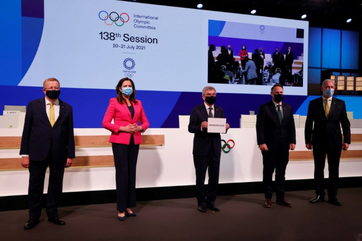 President of the International Olympic Committee (IOC) Thomas Bach (C) poses with members of the Brisbane 2032 delegation (L-R) President of Australian Olympic Committee John Coates, Queensland Premier Annastacia Palaszczuk