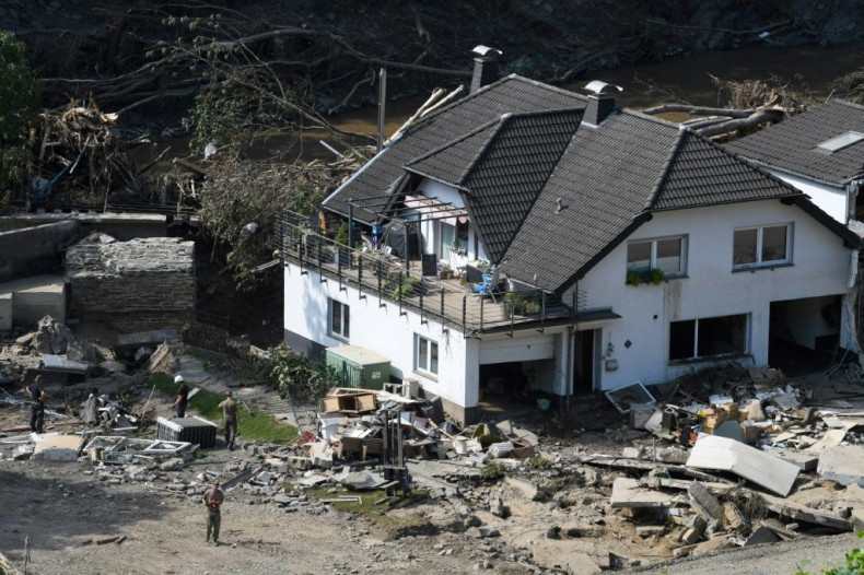 Workers on Thursday clear around a damaged home in Marienthal, in the Bad Neuenahr-Ahrweiler distict of western Germany, more than week after deadly floods struck the region