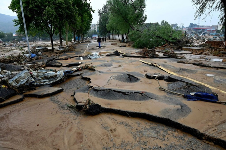 Rescuers with shovels and helmets battled a thick layer of mud at least a foot deep