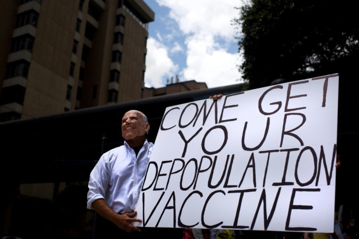 An anti-vaccine protester dressed up as Joe Biden in June 2021 promoted one of several conspiracies that have contributed to low vaccination rates, particulary among US Republicans