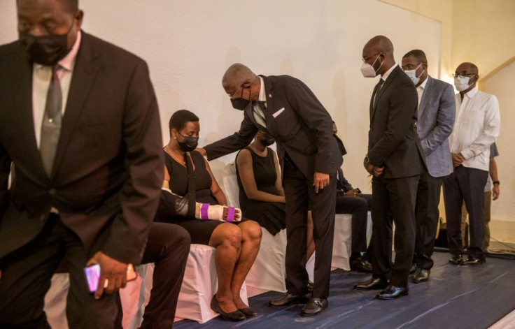 Family members and friends offer condolences to Martine Moise, the widow of slain president Jovenel Moise, and her children during a Catholic Mass in Cap-Haitien