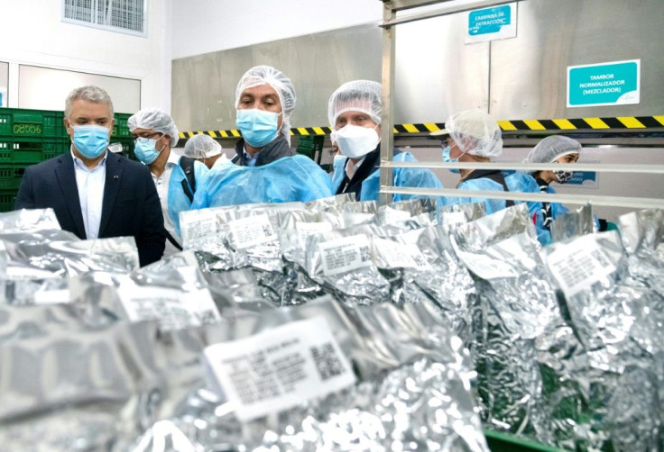 Colombian President Ivan Duque (L) visits the Clever Leaves company in Boyaca, Colombia on July 23, 2021