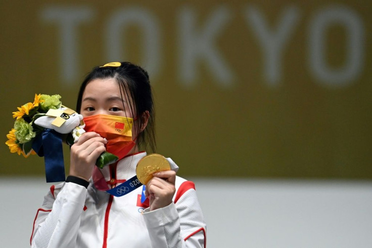 China's Yang Qian celebrates after winning the women's 10m air rifle competition at the 2020 Olympics