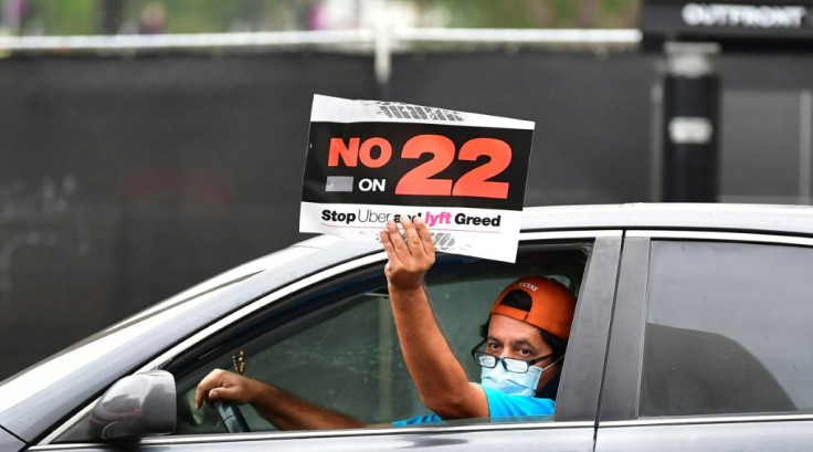 A rideshare driver demonstrates in Los Angeles against Proposition 22, which effectively overturned a state law requiring Uber, Lyft and other app-based, on-demand delivery services to reclassify their drivers and provide employee benefits