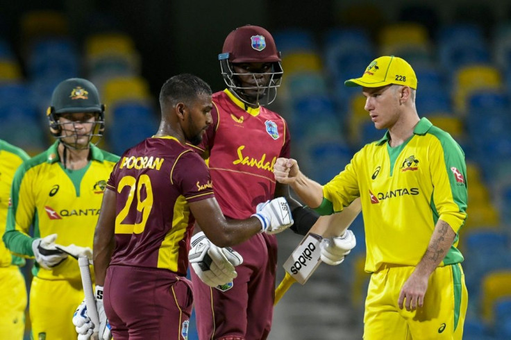 Nicholas Pooran and Alzarri Joseph of West Indies are congratulated by Adam Zampa (right) of Australia for winning the 2nd ODI between West Indies and Australia at Kensington Oval, Bridgetown, Barbados