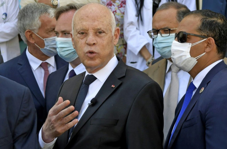 Tunisia's President Kais Saied speaks with reporters in the capital Tunis on Friday, during a ceremony for the receipt of French aid to combat Covid-19