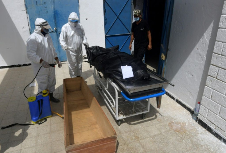 Tunisian municipal employees disinfect the body of a COVID-19 victim at the Ibn al-Jazzar hospital in the city of Kairouan earlier this month