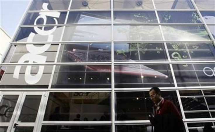 A man walks past an &#039;Acer&#039; office during the Mobile World Congress in Barcelona