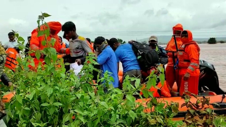 Rescuers in India are combing through mud and debris in a desperate search for survivors and to evacuate villagers as the death toll from heavy monsoon rains climbs with nearly 90,000 evacuated.