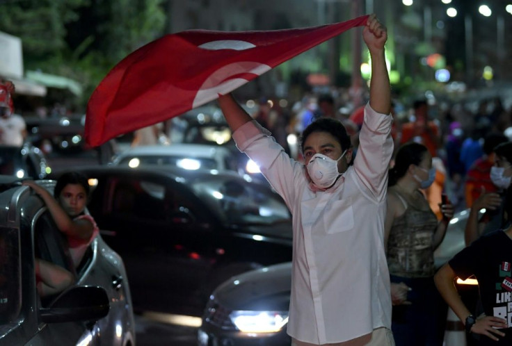 People celebrate in the streets of Tunis after Tunisian President Kais Saied announced the suspension of parliament and the dismissal of the prime minister