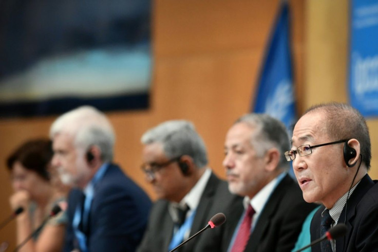 IPPC chairman Hoesung Lee (R) and co-chairs attend a press conference on a special IPCC report on climate change and land on August 8, 2019 in Geneva