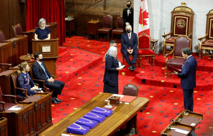 Mary Simon is sworn in as her husband Whit Fraser, Prime Minister Justin Trudeau, and his wife Sophie look on