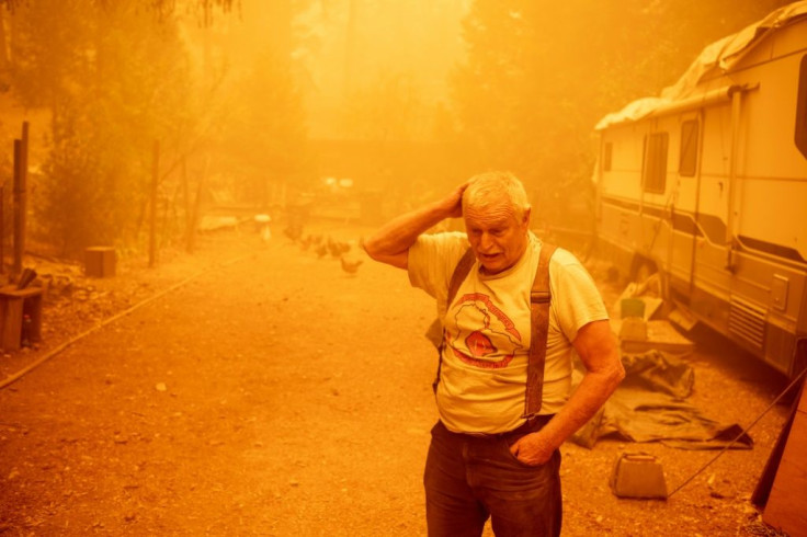 Resident Jon Cappleman prepares to defend his home during the Dixie fire in Twain, California