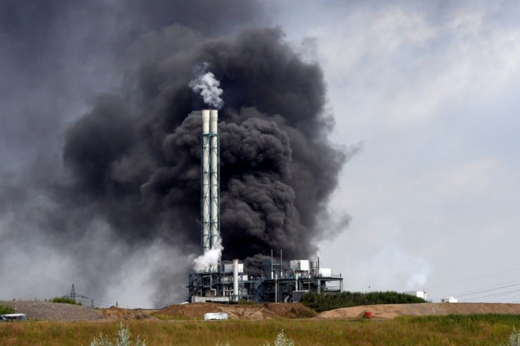 Smoke rises from a landfill and waste incineration area at the Chempark industrial park run by operator Currenta following an explosion in Leverkusen in western Germany, on July 27, 2021At least 16 people were injured and five missing after an explosio