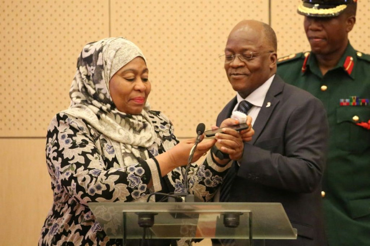 Former president John Magufuli and his deputy, Samia Suluhu Hassan. They are pictured speaking on a mobile phone to Kenyan leader Uhuru Kenyatta in July 2019