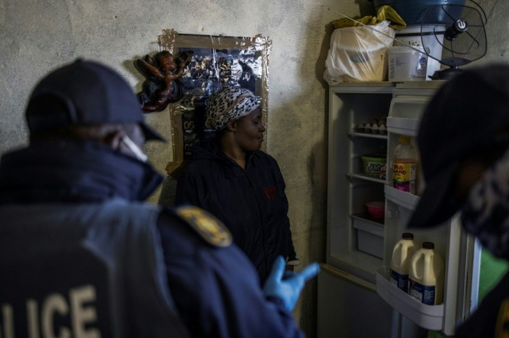 A woman is questioned about the contents of her fridge. Food, more than electronic goods, accounted for most of items that were confiscated on Tuesday