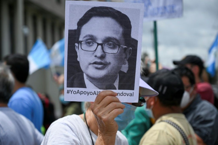 A demonstrator holds a portrait of dismissed special prosecutor Juan Francisco Sandoval during a protest outside the Public Ministry's headquarters in Guatemala City on July 24, 2021