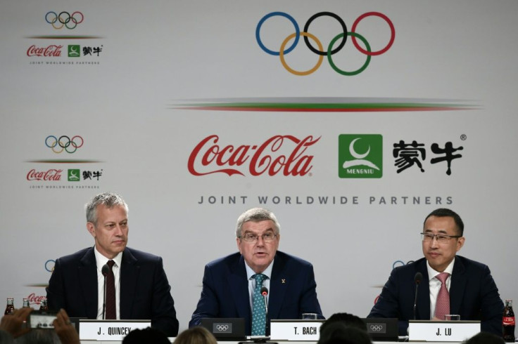 Coca-Cola CEO James Quincey (left), whose company is a historic sponsor of the Olympics, takes part in a 2019 news conference in Lausanne with International Olympic Committee president Thomas Bach (center) and China Mengniu Dairy CEO Jeffrey Minfang