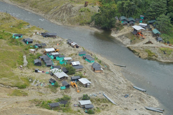 This aerial view shows a camp of an illegal gold mine along of Timbiqui River, departament of Cauca, Colombia, on August 9, 2016, during an operation against illegal gold mining