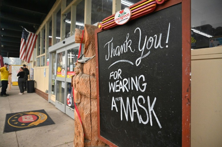 A sign reads "Thank you! For Wearing A Mask," outside a supermarket in Indian Valley, California