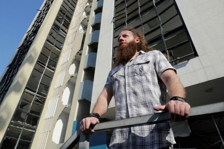 Blast survivor Shady Rizk at the building hosting his former office, overlooking Beirut port
