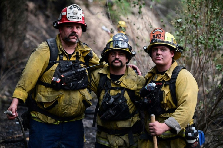 Firefighters -- such as these pictured taking a breather as they put out hot spots from the Dixie Fire, in Twain, California -- are increasingly reaching out to support groups to deal with the stress of ever-longer fire seasons