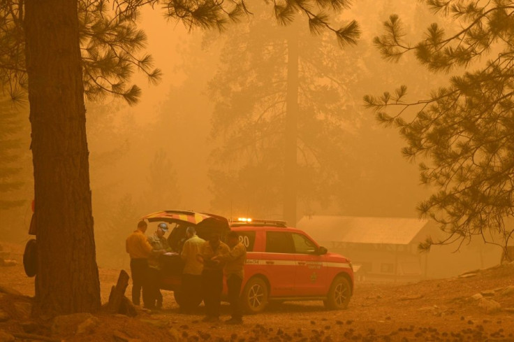 Firefighters plan strategy in the evacuation zone of the Dixie Fire, in Twain, California
