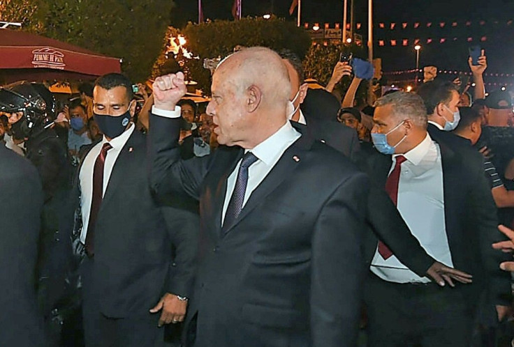 Tunisian President Kais Saied gestures to supporters in Tunis after he suspended parliament for 30 days, seen here in a picture by the Tunisian Presidency on July 26, 2021