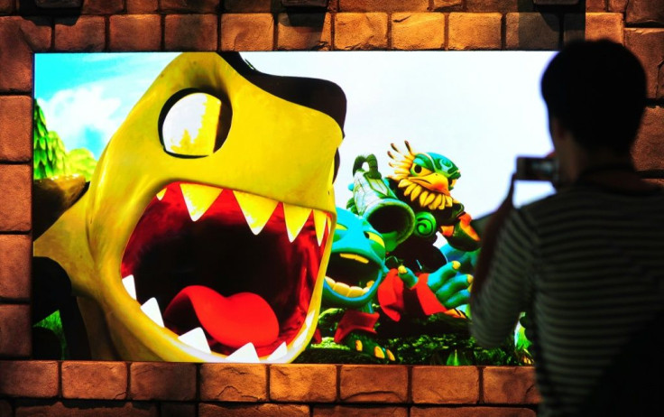 A large screen shows scenes from the game Skylander's Giants by Activision on the second day of the E3 videogame extravaganza in 2012