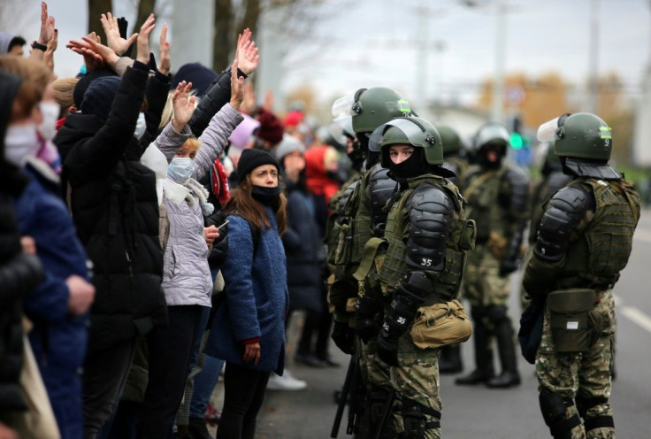 Law enforcement officers block opposition protesters in central Minsk in November 2020