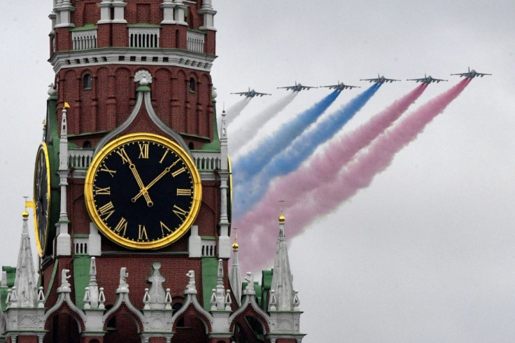 Russian Sukhoi Su-25 assault aircrafts release smoke in the colors of the Russian flag during the Victory Day military parade on May 9, 2021 amid renewed efforts with the United States on arms control