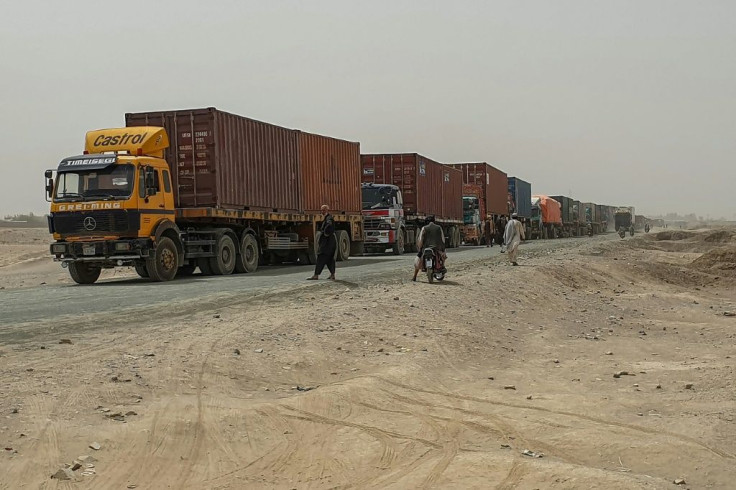 Trucks carrying goods destined for Afghanistan's second biggest city line up near Chaman, in Pakistan, waiting to cross the border. Traders say they are being taxed by the Taliban as well as Afghan government officials, and also face extortion or robbery 