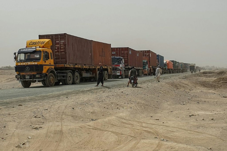 Trucks carrying goods destined for Afghanistan's second biggest city line up near Chaman, in Pakistan, waiting to cross the border. Traders say they are being taxed by the Taliban as well as Afghan government officials, and also face extortion or robbery