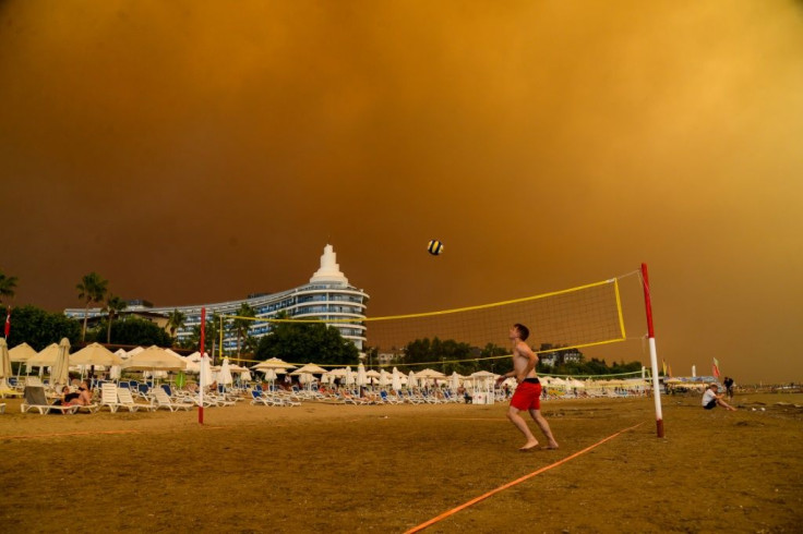 Dark smoke drifts over a hotel complex during a massive forest fire which engulfed a Mediterranean resort region on Turkey's southern coast near the town of Manavgat, on July 29, 2021