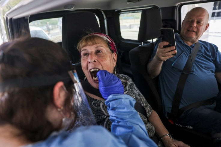 In Israel, where this woman is being tested for Covid-19, the government has authorized booster shots for those over the age of 60