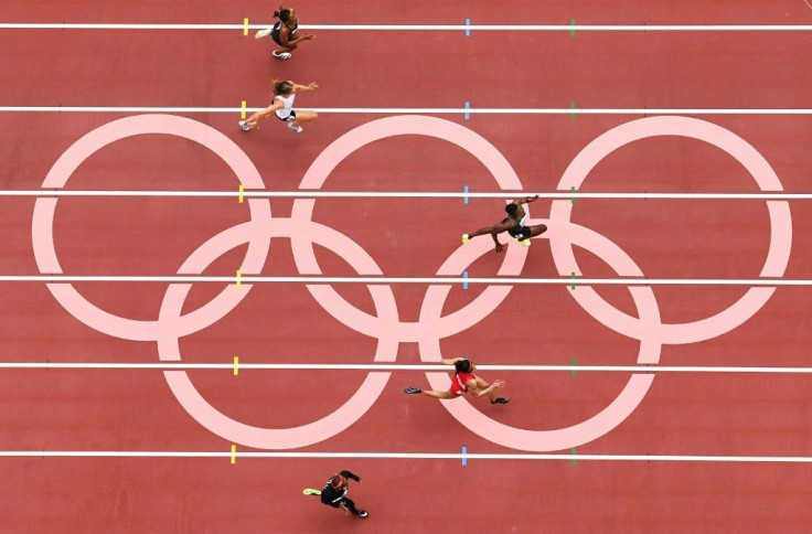 Athletes compete in the women's 100m heats