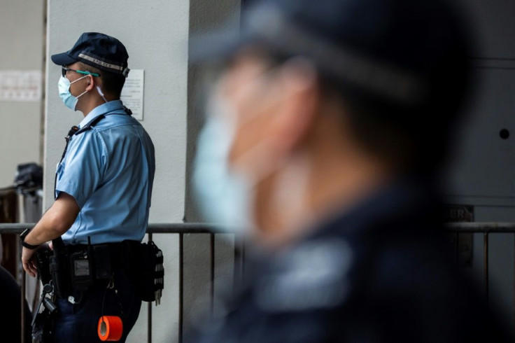 Police stand guard outside the High Court in Hong Kong as Tong Ying-kit faced sentencing after he was convicted of terrorism and inciting secession in the first trial conducted under a national security law imposed by China