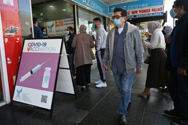 Sydney residents queue outside a pharmacy for a Covid-19 vaccination. Prime Minister Scott Morrison said Australia will reopen its borders and end lockdowns when 80% of the population is fully vaccinated
