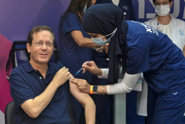 President Isaac Herzog receives a third dose of the Pfizer/BioNTech Covid-19 vaccine as Israel launches its booster shot campaign for over 60s