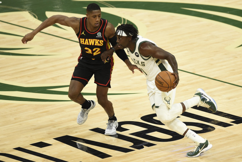 Jrue Holiday #21 of the Milwaukee Bucks drives against Kris Dunn #32 of the Atlanta Hawks
