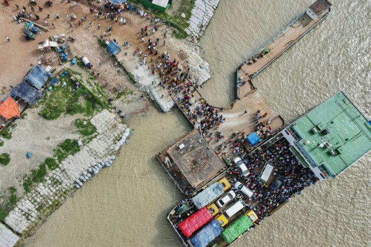 People disembark from a ferry to return to work as the Bangladesh government relaxed a lockdown for all export oriented factories