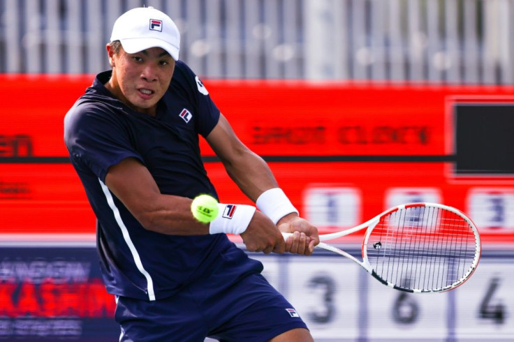 American Brandon Nakashima looks to return a shot from Emil Ruusuvuori of Finland during a match at the Atlanta Open