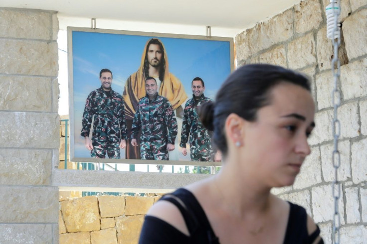 Karlen Hitti Karam's husband, brother and cousin -- pictured behind her -- were firefighters killed in the Beirut blast that claimed 214 lives