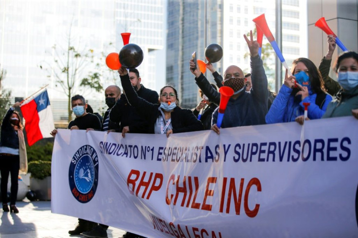 Workers of the Escondida copper mine protest during a strike outside BHP Billiton's offices, in May