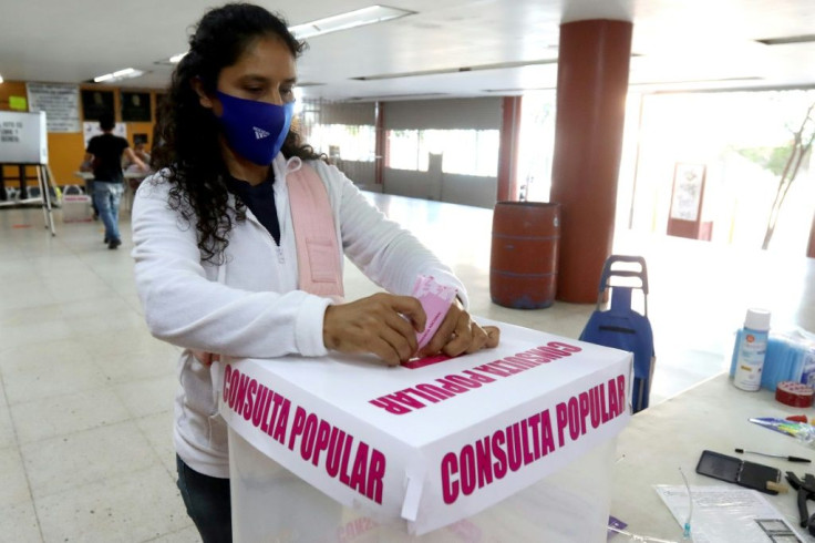 A woman casts her vote during a national referendum on whether to investigate past leaders for corruption, in Guadalajara, Jalisco state, Mexico, on August 1, 2021