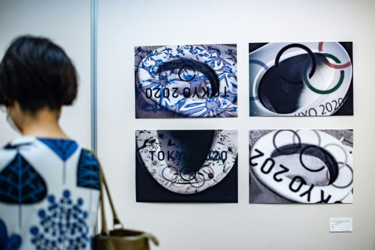 A visitor walks in front of "Toto Nolympics" by Shoko Miki during an anti-Olympics art exhibition in Tokyo